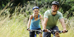 Adult riding bicycles outdoors