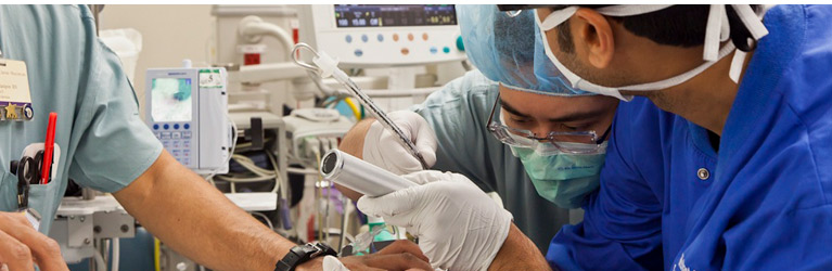 Anesthesiology Resident intubating in operating room